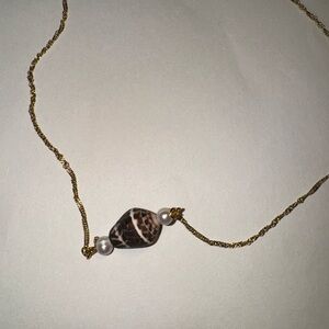 Handcrafted gold cone shell necklace with natural pearls